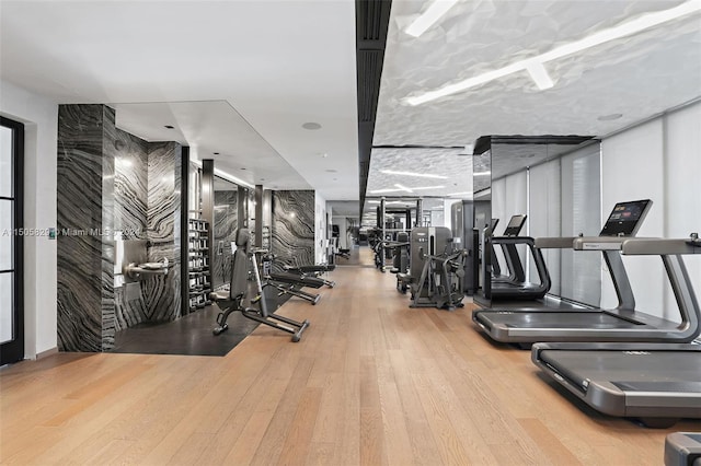 workout area with light wood-type flooring