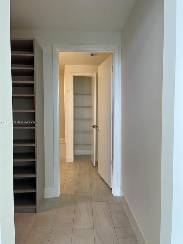 hallway featuring light tile patterned flooring