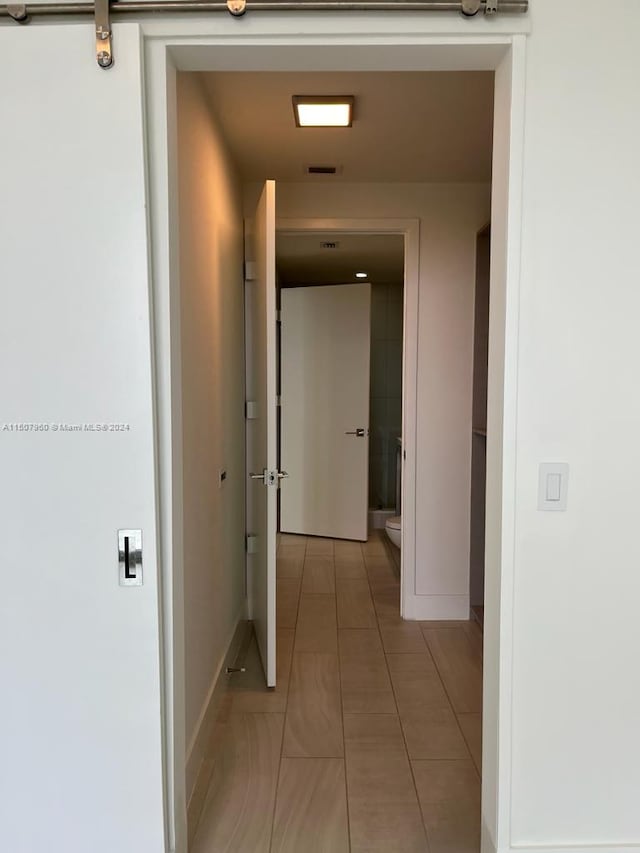 hall featuring light tile patterned floors