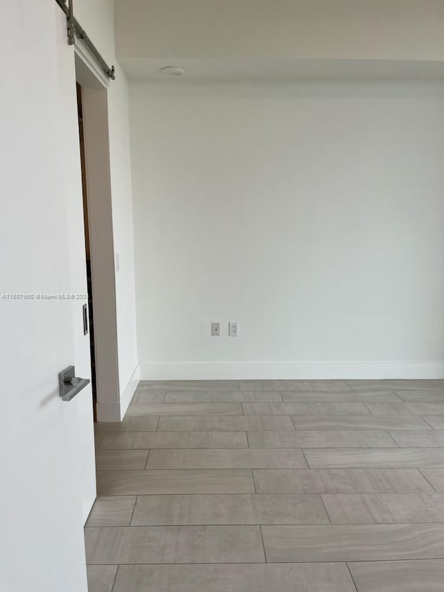 spare room featuring a barn door