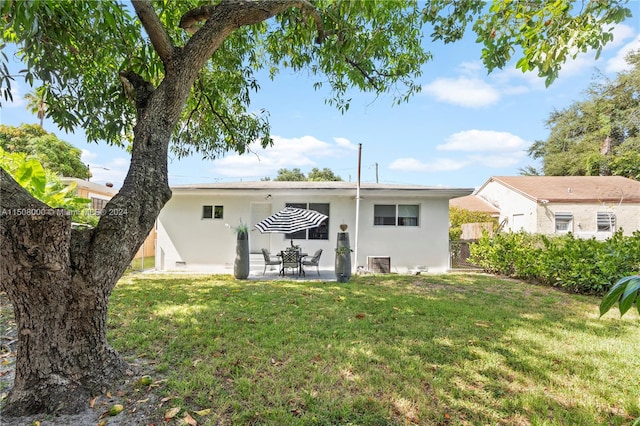 rear view of property with a yard, central AC, and a patio area