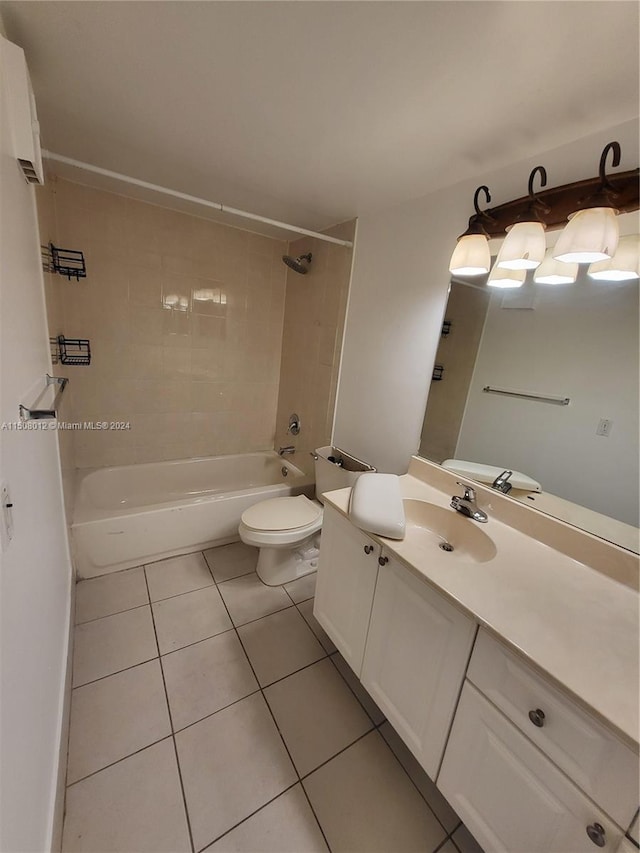 full bathroom featuring tile floors, toilet, vanity, and tiled shower / bath