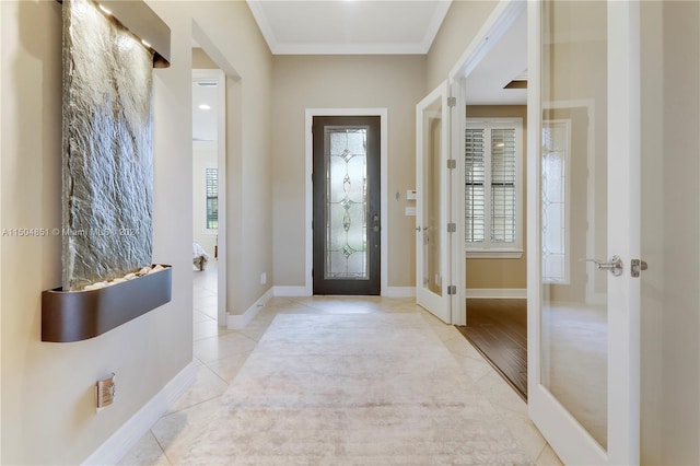 entrance foyer featuring crown molding, french doors, and light tile patterned flooring