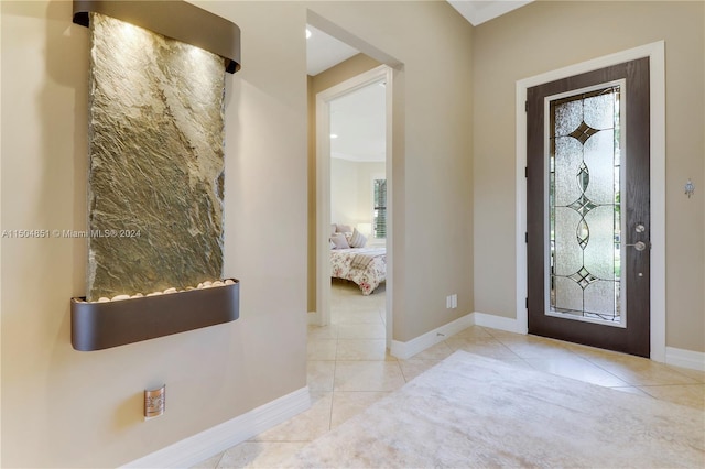 foyer entrance with light tile patterned flooring