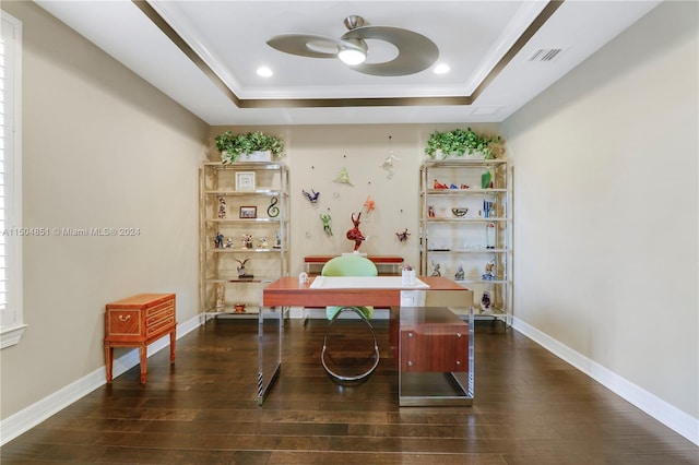 home office with a raised ceiling, ceiling fan, and dark wood-type flooring