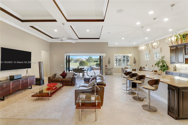 living room with coffered ceiling, sink, crown molding, ceiling fan, and beam ceiling