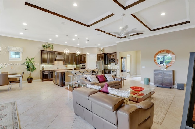 living room with ceiling fan, light tile patterned floors, coffered ceiling, and ornamental molding