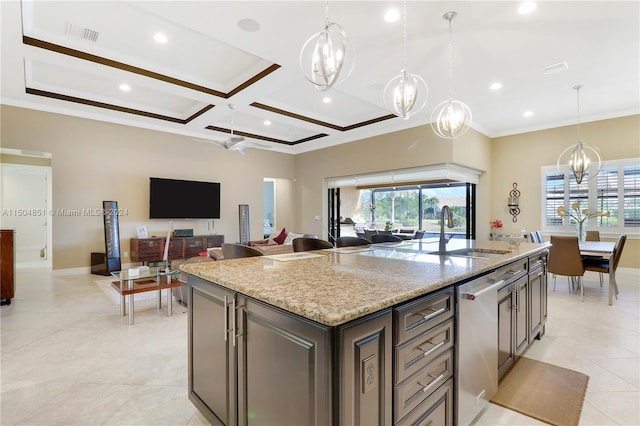 kitchen with light stone counters, a center island with sink, pendant lighting, and coffered ceiling