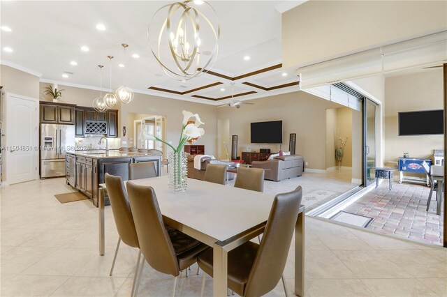 dining area with coffered ceiling, ornamental molding, sink, a chandelier, and light tile patterned flooring