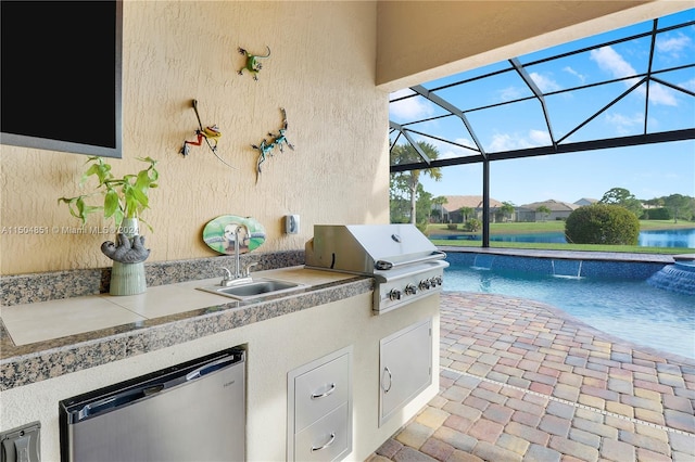 view of patio with sink, exterior kitchen, a lanai, grilling area, and a water view