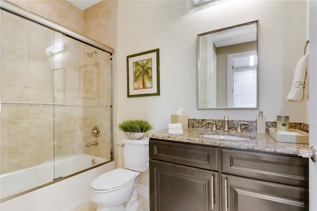 full bathroom featuring combined bath / shower with glass door, vanity, and toilet