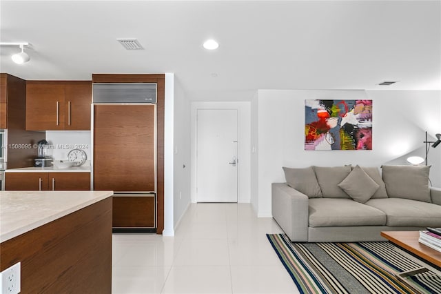 tiled living room with rail lighting