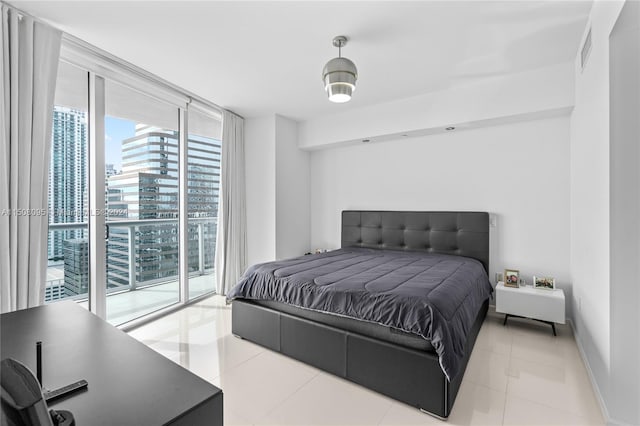 bedroom with access to outside, expansive windows, and light tile floors