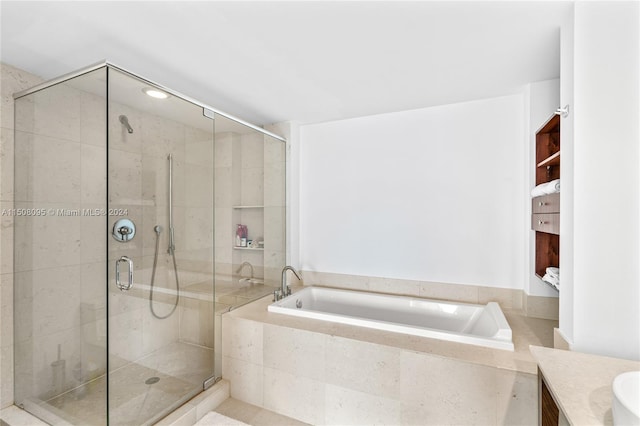 bathroom featuring separate shower and tub and vanity