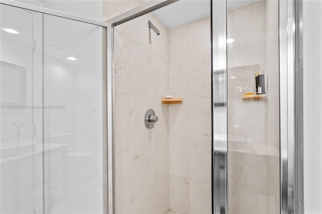 bathroom with a shower with shower door