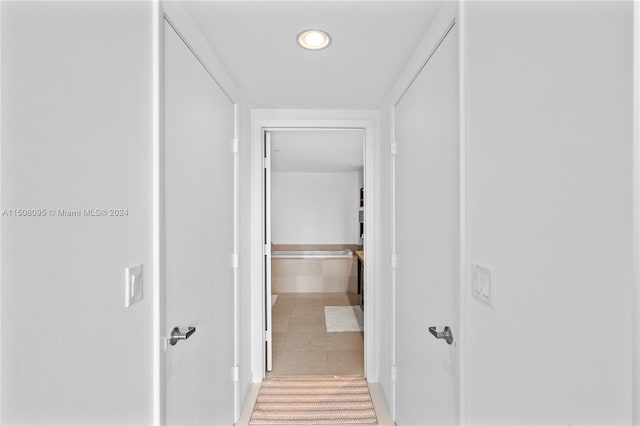 hall featuring light tile flooring