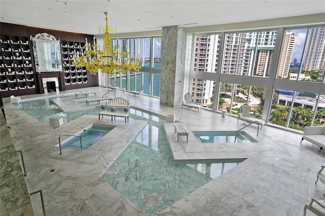 view of pool featuring an inviting chandelier and an indoor in ground hot tub