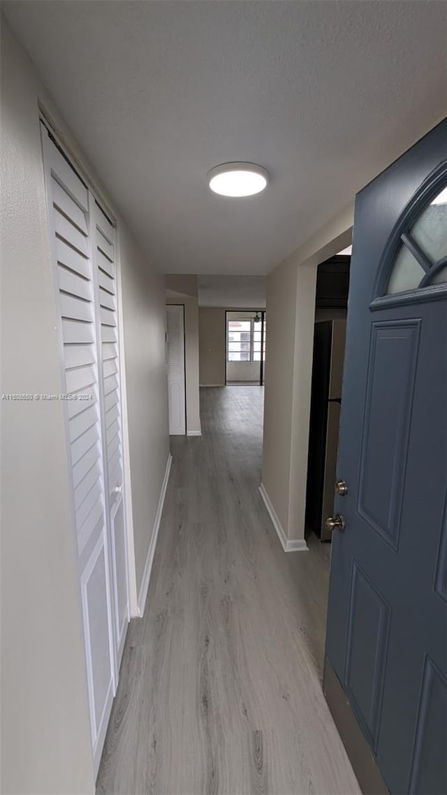 corridor with light wood-type flooring