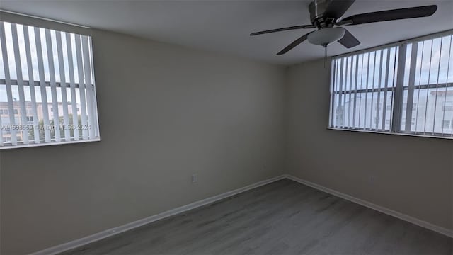 spare room featuring ceiling fan and hardwood / wood-style flooring