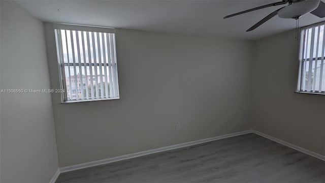 unfurnished room with ceiling fan and hardwood / wood-style flooring