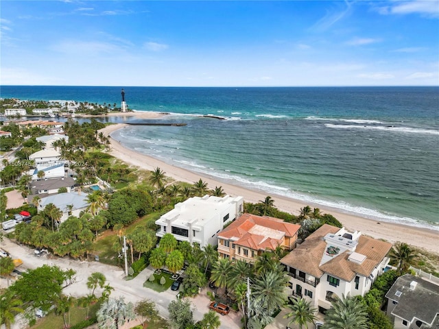 drone / aerial view with a water view and a beach view