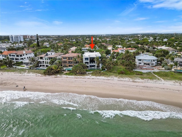 drone / aerial view with a beach view and a water view