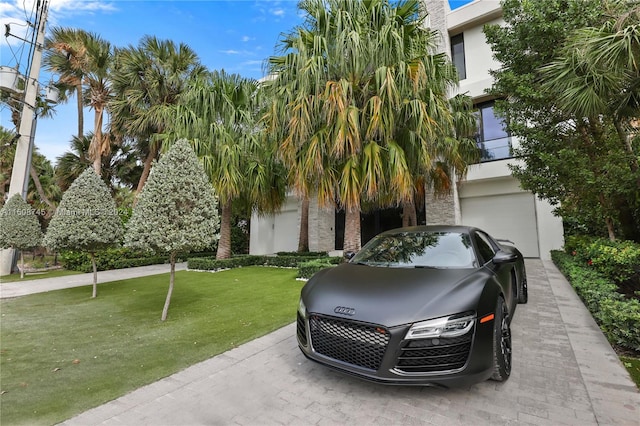 view of front of property featuring a garage and a front lawn