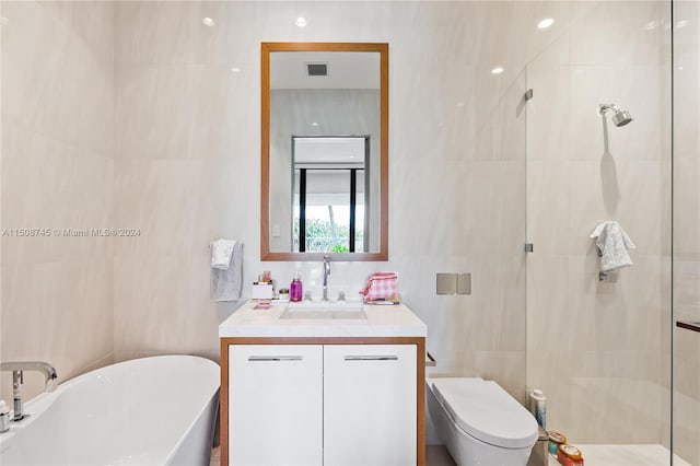 full bathroom featuring vanity, toilet, tile walls, and separate shower and tub