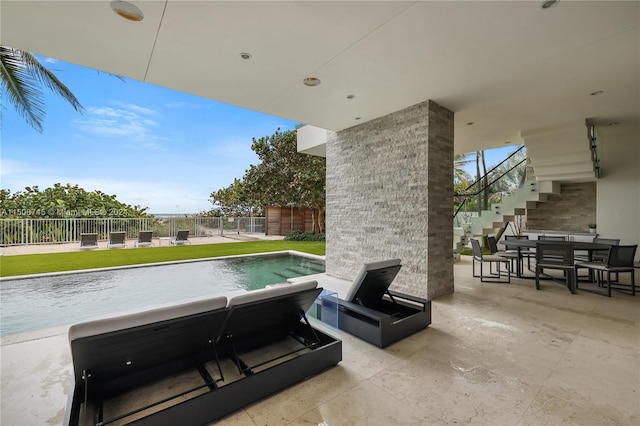 view of patio with a fenced in pool