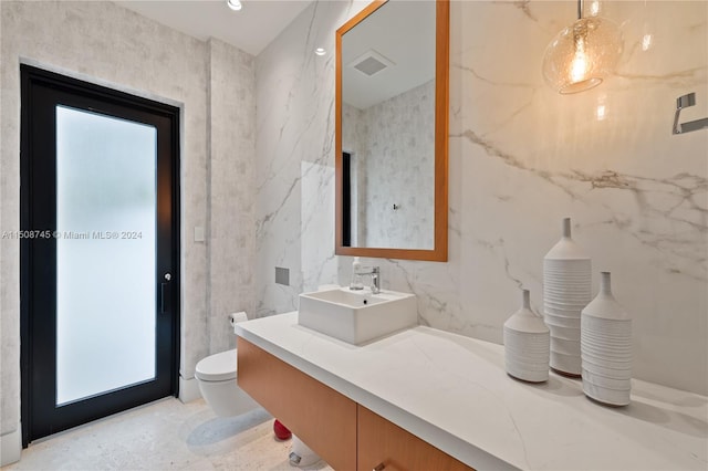 bathroom featuring vanity and toilet