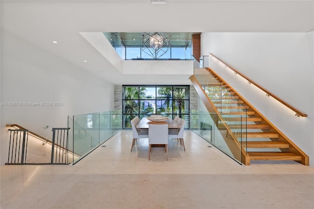 stairway featuring an inviting chandelier