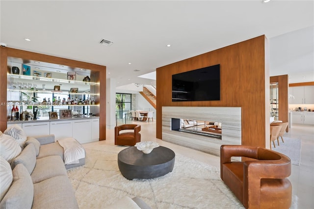 living room featuring bar and a fireplace