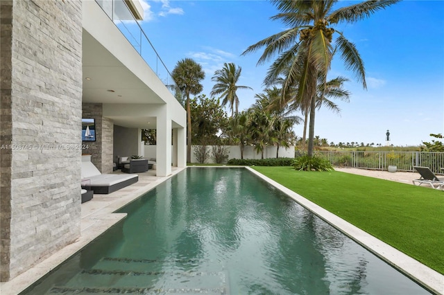 view of swimming pool with a yard and a patio