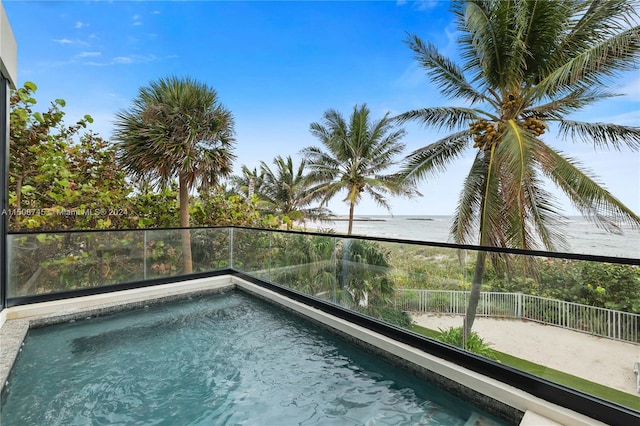 view of swimming pool with a water view