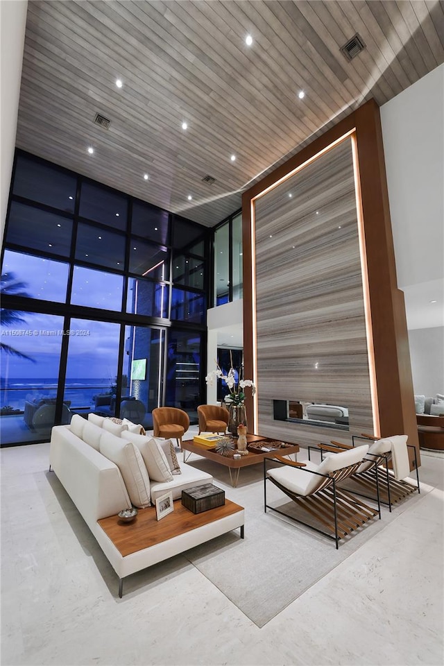 living room with expansive windows and wooden ceiling