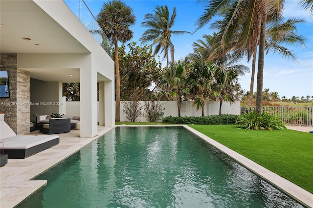 view of swimming pool with a yard, an outdoor hangout area, and a patio