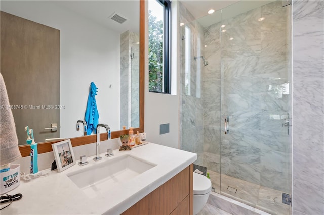 bathroom with vanity, toilet, and an enclosed shower