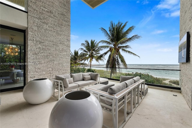 view of patio featuring a beach view, a water view, and outdoor lounge area