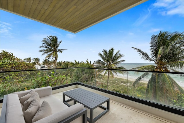 balcony featuring an outdoor living space and a water view