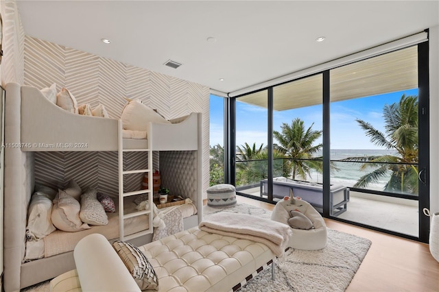 interior space with a water view, light hardwood / wood-style flooring, and access to outside