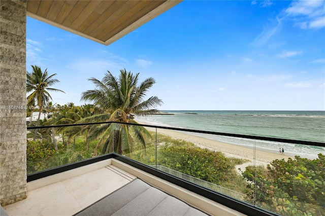 balcony featuring a beach view and a water view