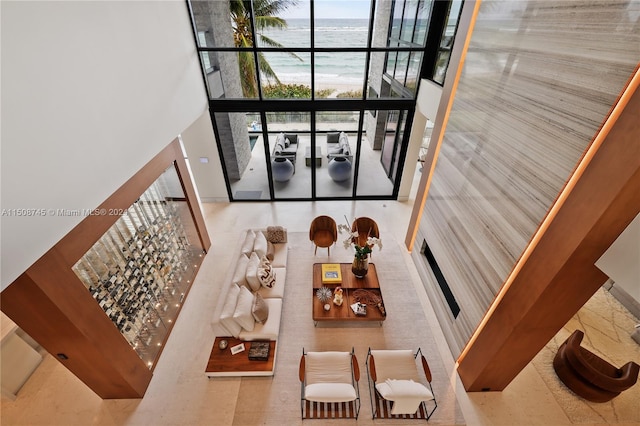 living room with a towering ceiling and a water view