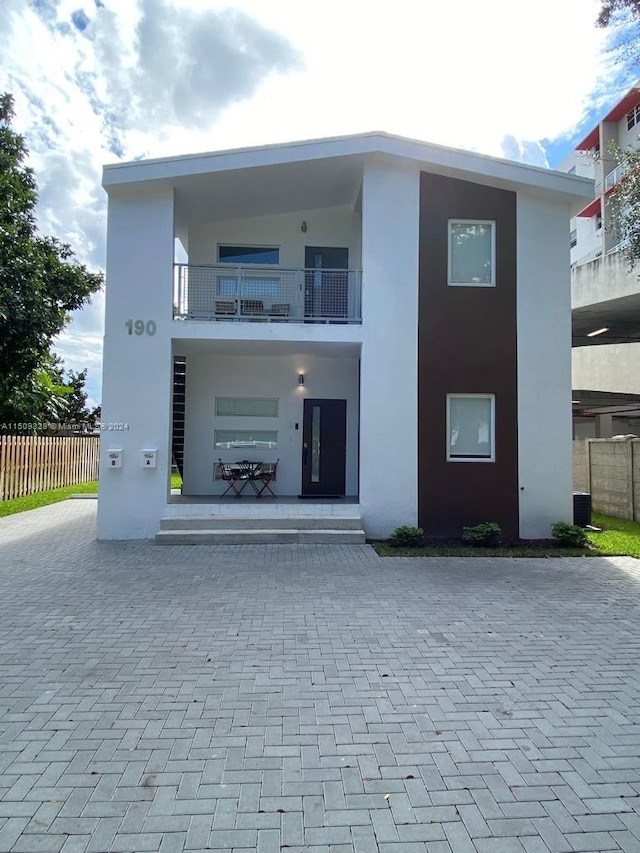 back of house with french doors and a balcony