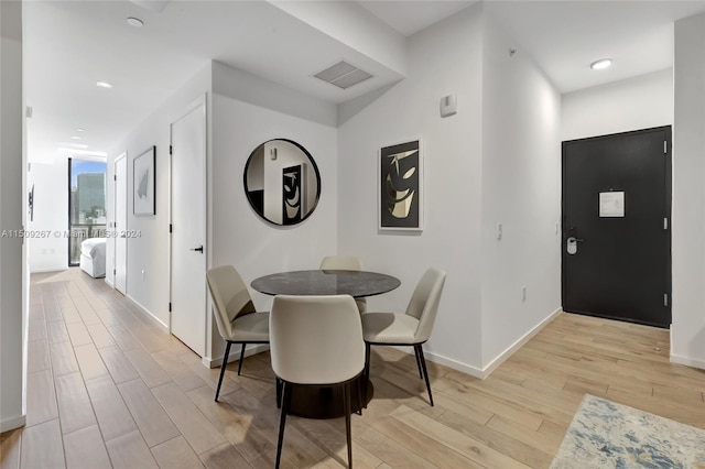 dining space with light hardwood / wood-style flooring