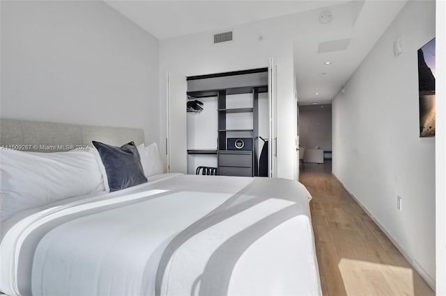 bedroom featuring light hardwood / wood-style flooring and a closet