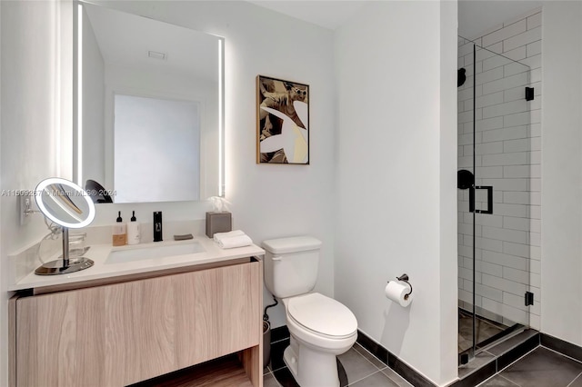 bathroom featuring vanity, toilet, a shower with shower door, and tile patterned flooring