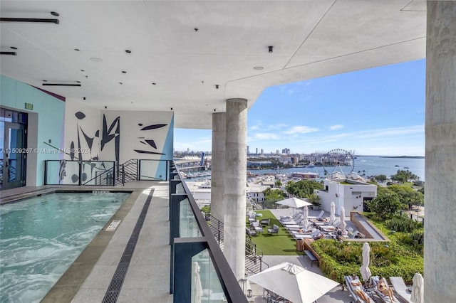 view of swimming pool with a water view