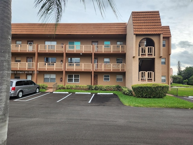 view of building exterior featuring uncovered parking