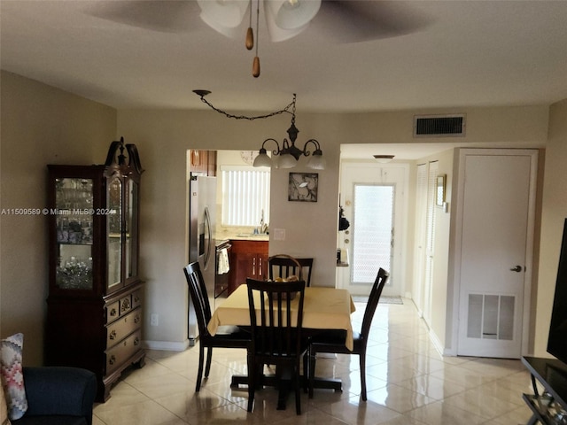 dining room with an inviting chandelier and light tile floors