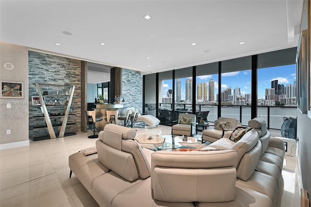 living room with a water view, expansive windows, and light tile floors